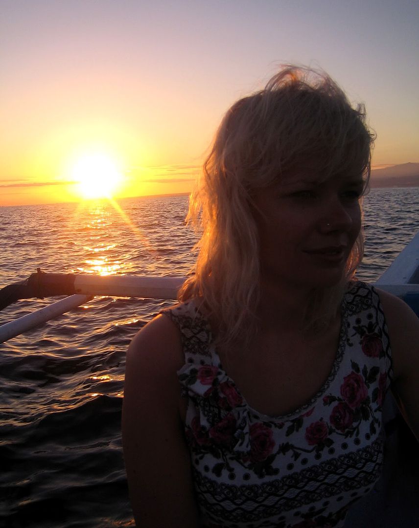 A photo of marisa at balinese sunrise with dolphins” Title=